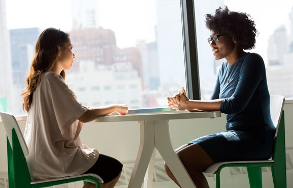 Young woman meeting with business woman