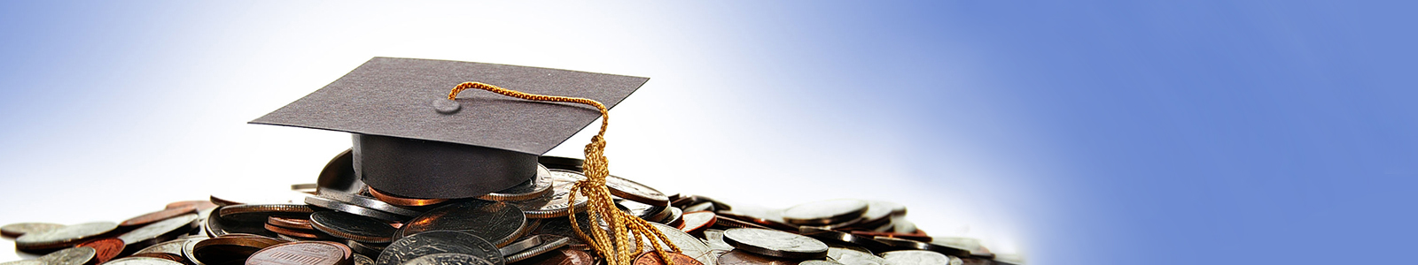 A graduate cap sitting on a pile of money