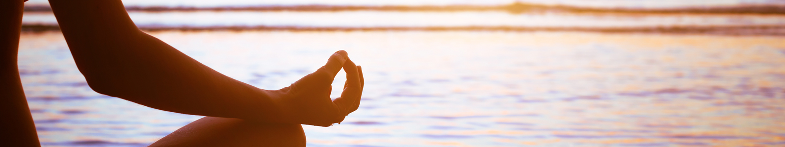 Banner showing someone meditating by a lake